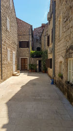 Empty alley amidst buildings in city