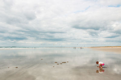 People on beach against sky