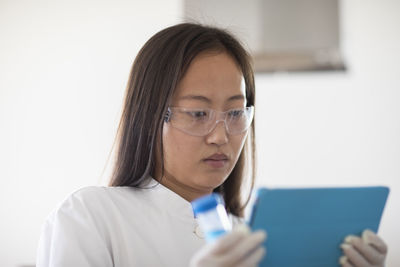 Scientist female with sample and tablet in a lab