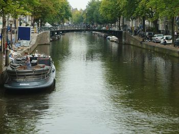 Boats in river with buildings in background