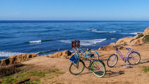 Bicycle on beach against sky