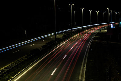 High angle view of light trails on highway at night