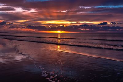 Scenic view of sea against romantic sky at sunset