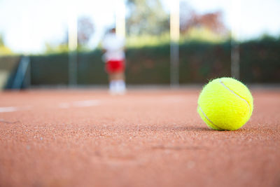 Close-up of yellow ball on tennis field