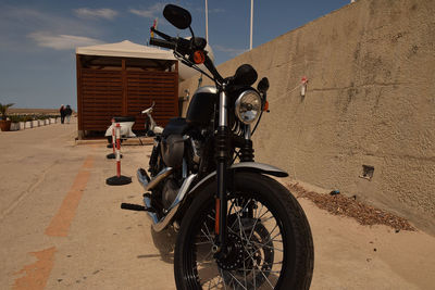 Motorcycle parked by wall