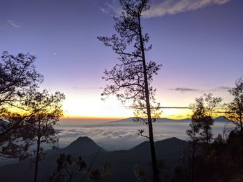 Scenic view of silhouette mountains against sky at sunset