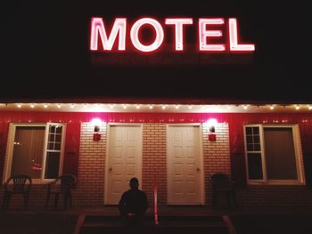 People on illuminated building at night