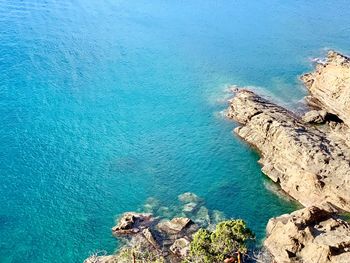 High angle view of rocks by sea