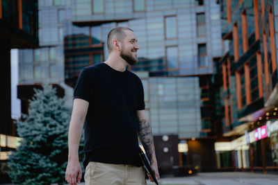 Side view of man standing in city