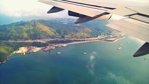 Cropped image of airplane flying over landscape