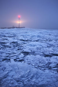 Scenic view of frozen sea against sky during winter