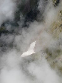 Smoke emitting from volcanic mountain