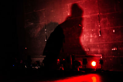 Silhouette people on illuminated street at night