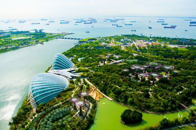 High angle view of city by sea against sky