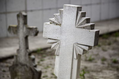 Close-up of cross in cemetery