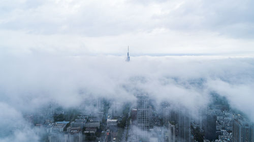 Aerial view of buildings in city during foggy weather