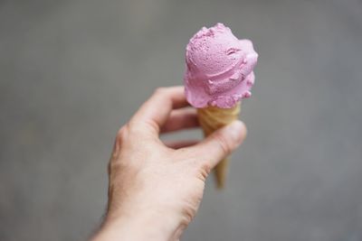 Close-up of hand holding ice cream