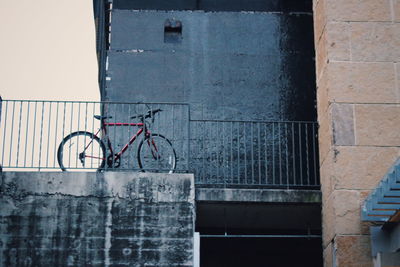 Low angle view of bicycle by railing