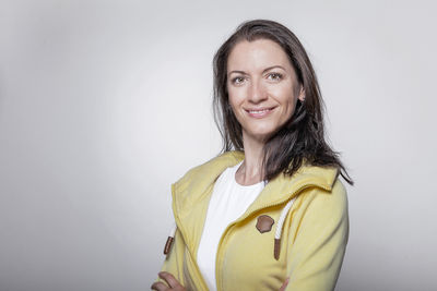 Portrait of smiling woman against white background