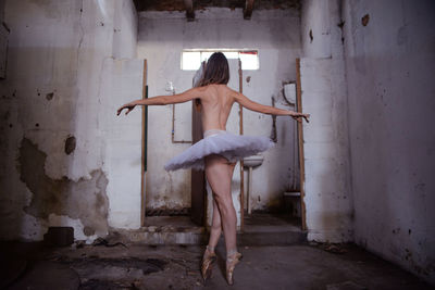 Full length of woman standing by railing