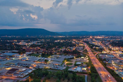 High angle view of illuminated buildings in city against sky