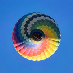 Low angle view of hot air balloon against clear blue sky