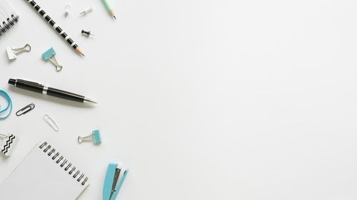 High angle view of pencils on table against white background