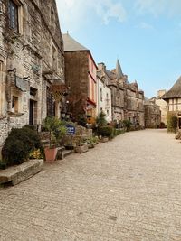 Street amidst buildings in town against sky