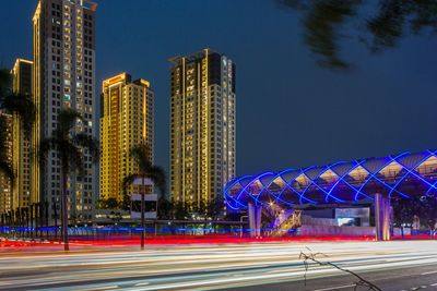 Low angle view of illuminated buildings in city at night