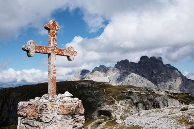 Low angle view of cross against sky