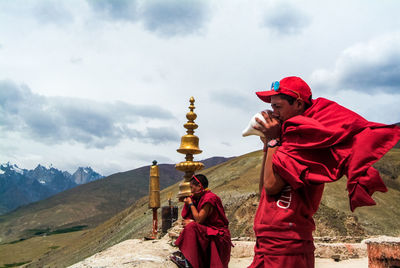 Portrait of young man standing against temple