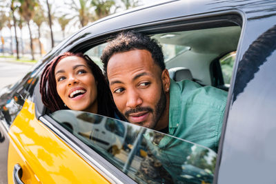 Portrait of smiling young woman in car