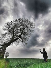 Man standing on field against sky