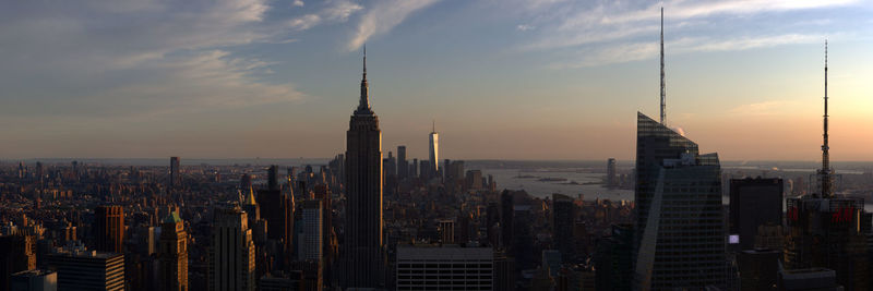 Panoramic view of buildings in city against sky during sunset