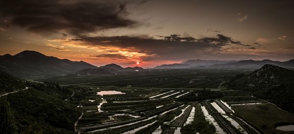 High angle view of field against sky during sunset