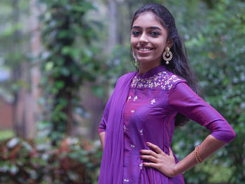 Portrait of young woman standing outdoors