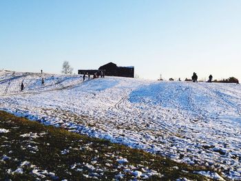 Scenic view of snow field against clear blue sky