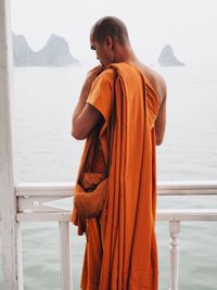 Man standing by sea against sky