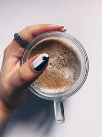 Cropped image of hand holding coffee cup