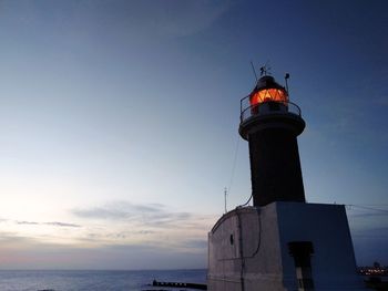 Lighthouse against sky at night