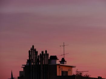 Low angle view of silhouette buildings against sky during sunset