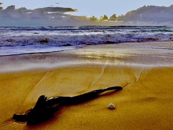 Close-up of sea against sky at sunset