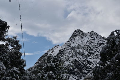 Low angle view of snowcapped mountains against sky