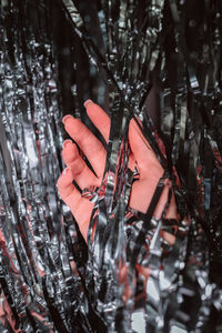 Woman hand touching silver glitter, christmas party and new year celebration concept