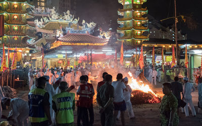 Crowd standing at illuminated market