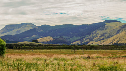 Scenic view of landscape and mountains against sky