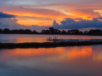 Scenic view of lake against orange sky