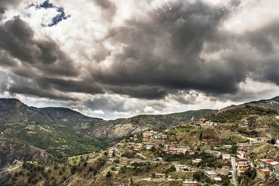 High angle view of mountains against cloudy sky