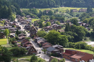 High angle view of townscape against trees and houses