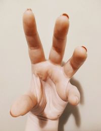 Close-up of human hand against white background